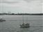 People Waving from a Boat