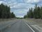 Byway driving north toward snowy mountains
